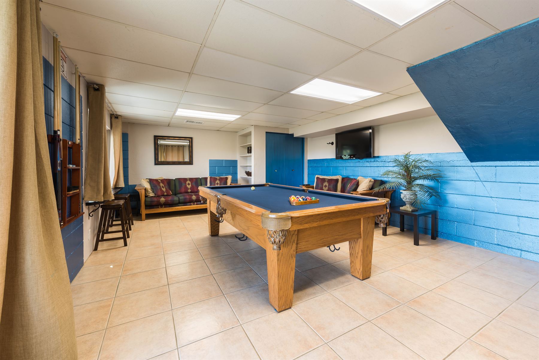 Oceanview Hideaway - Interior - Game room with pool table and two couches as well as a mounted TV