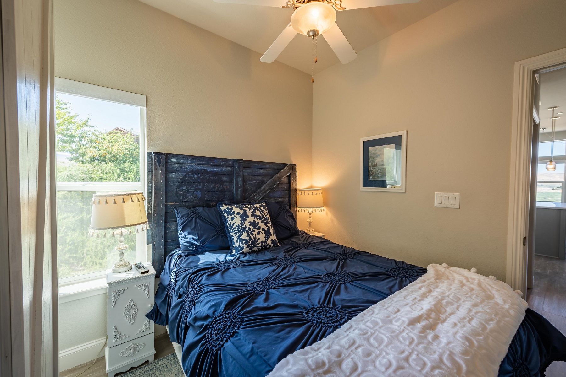 Guest room with Full bed and ceiling fan.