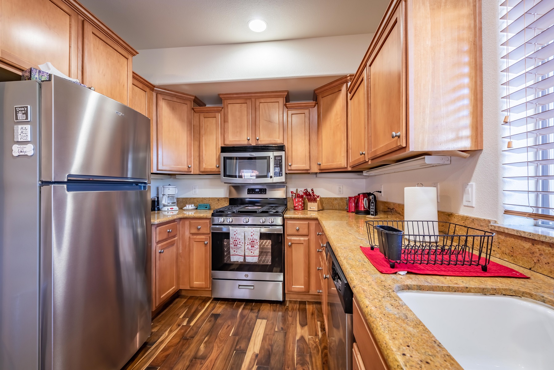 Fully-stocked kitchen with stainless steel appliances.