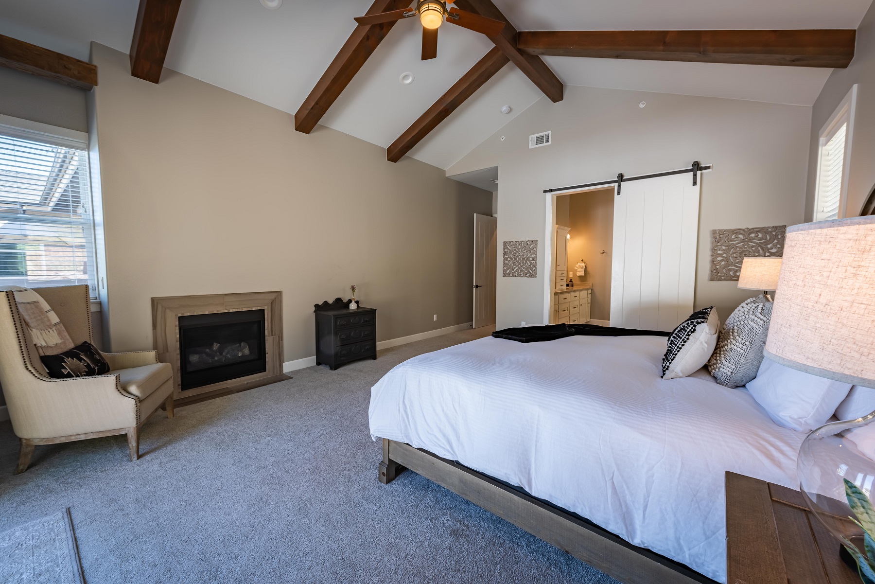 Master bedroom with wood beamed vaulted ceiling