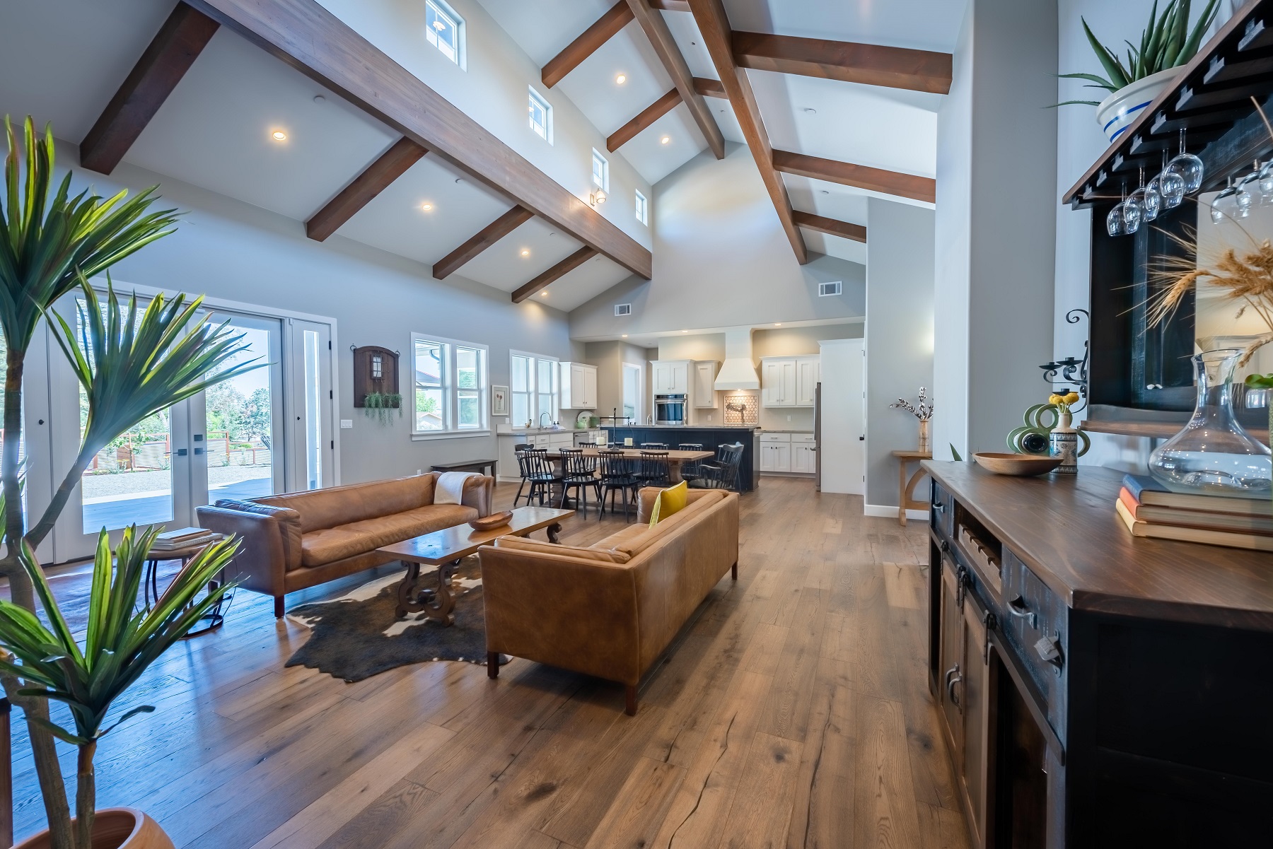 Grand great room with expansive 22 ft ceilings lined with wood beams