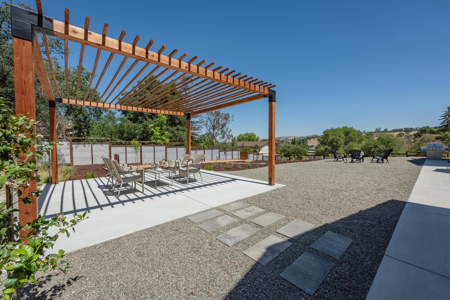 Trellis-covered patio with seating for four