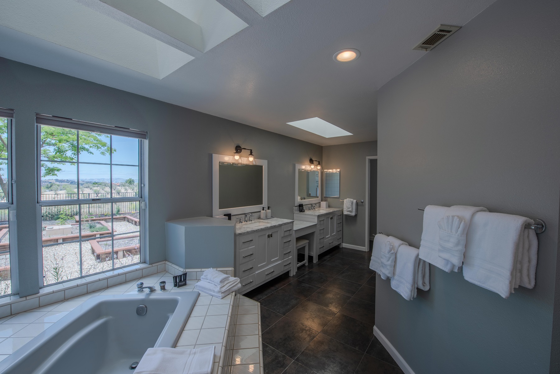 Master bath with large Jacuzzi tub. Soak while you watch a beautiful sunset Tub overlooking the herb garden. Two vanities, water closet and large walk-in shower complete the master en suite.