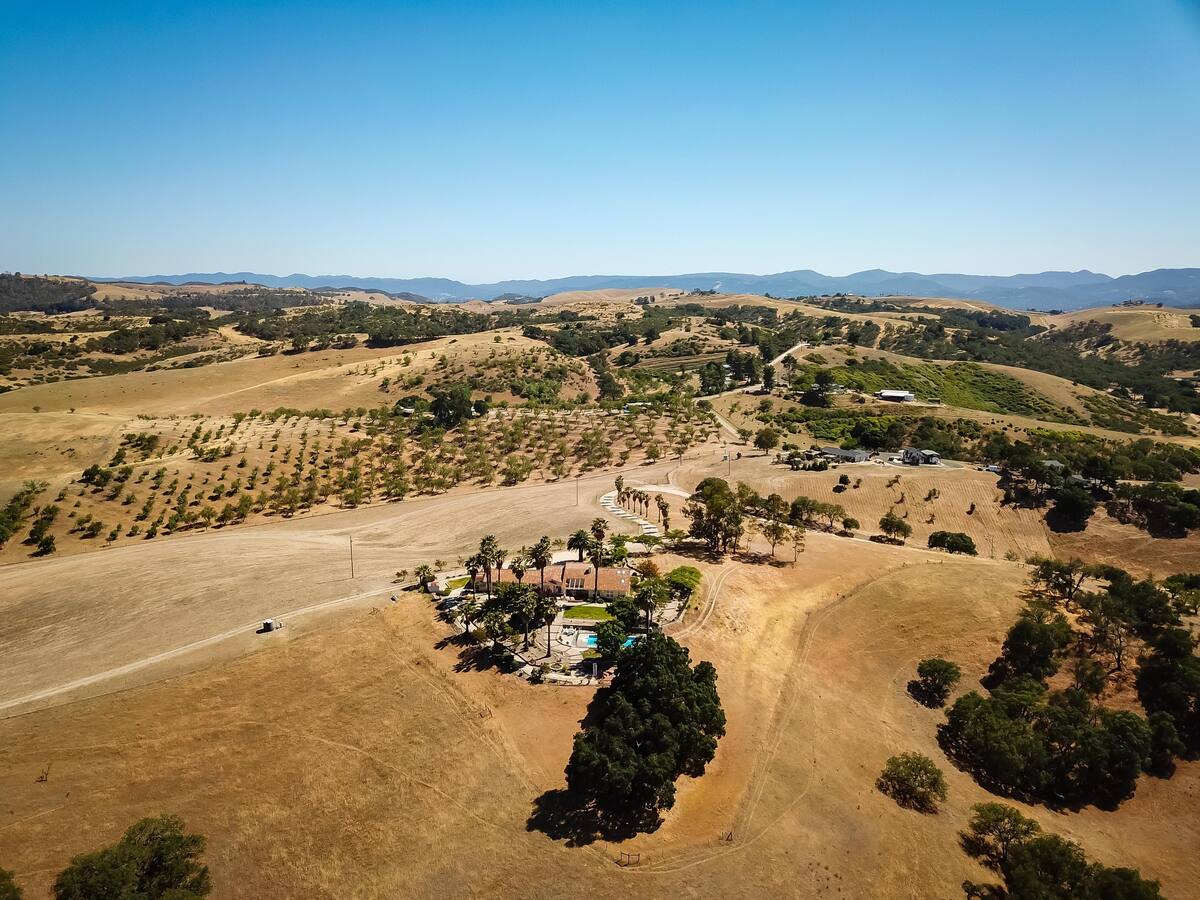 This is truly a hilltop oasis with 360 degree views of mountains, vineyards and Paso